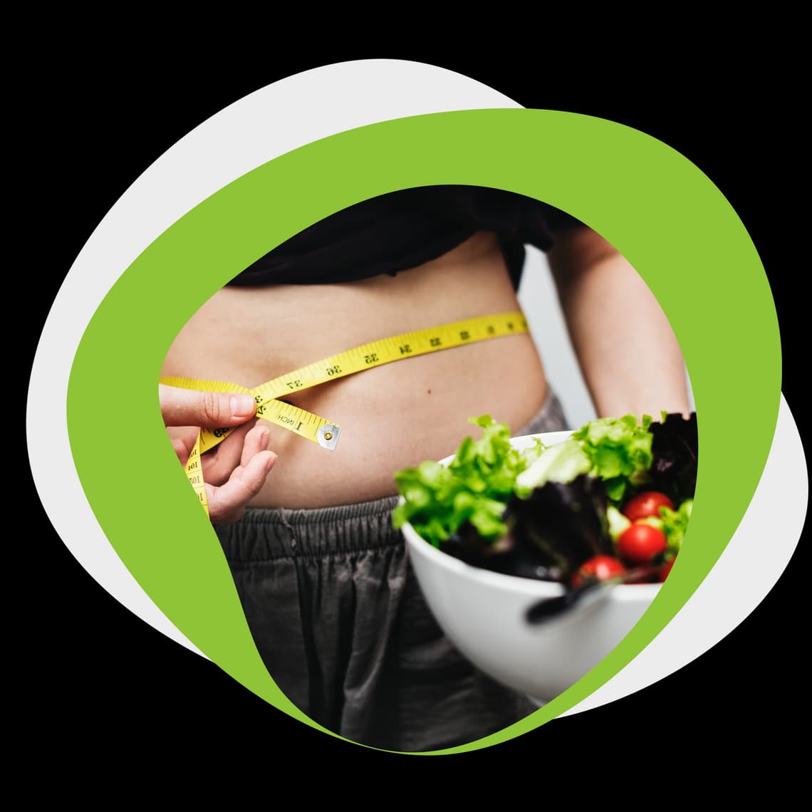 Person measuring waist with a tape measure and holding a bowl of salad